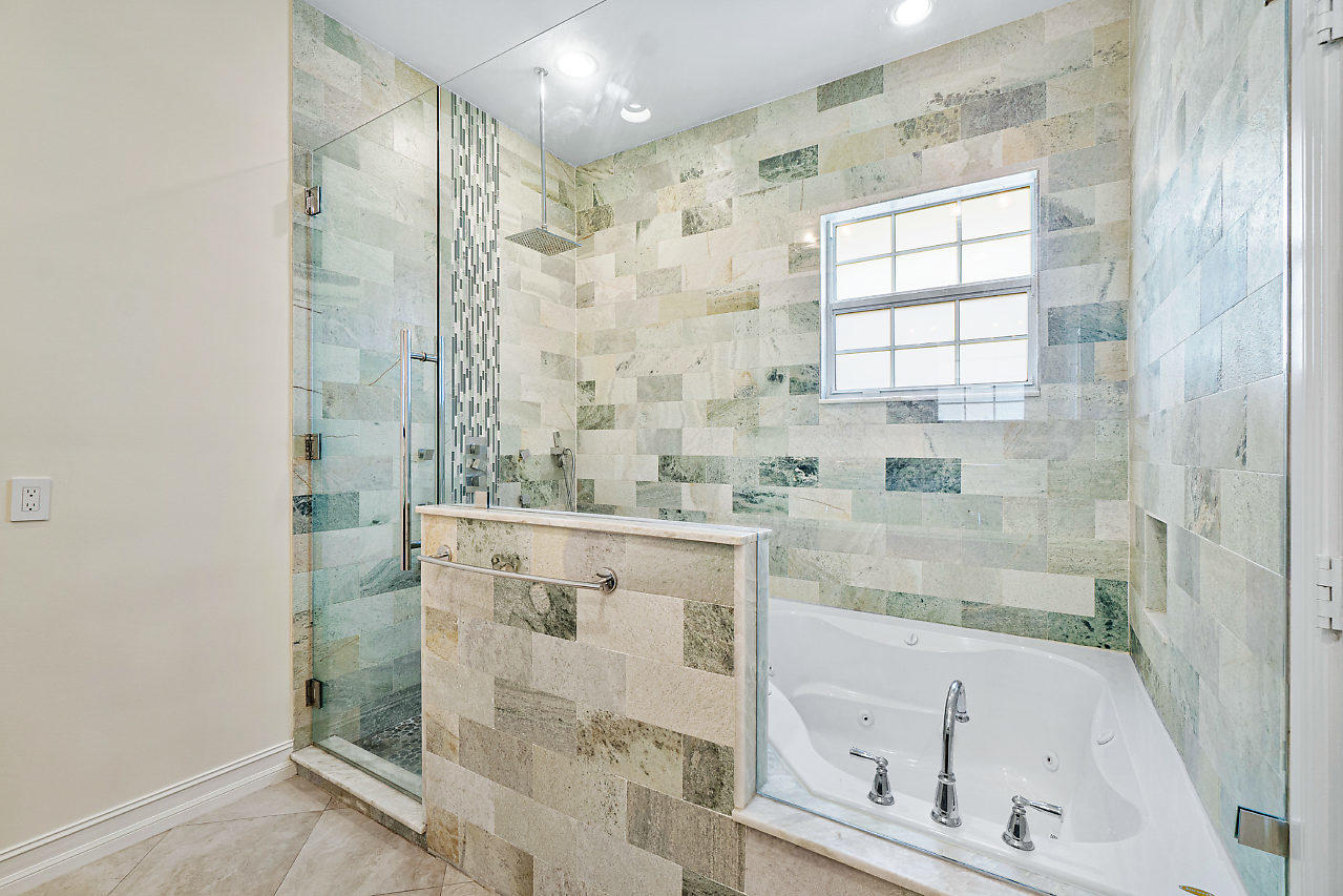 3605 Gulfstream Road Palm Springs, FL 33461 - Photo 14 of 35 a bathroom with a granite countertop shower mirror and a sink
