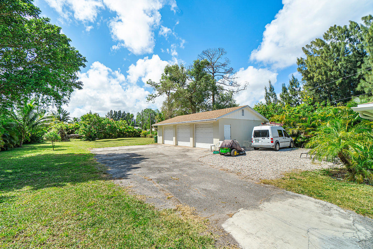 3605 Gulfstream Road Palm Springs, FL 33461 - Photo 19 of 35 a house with a yard