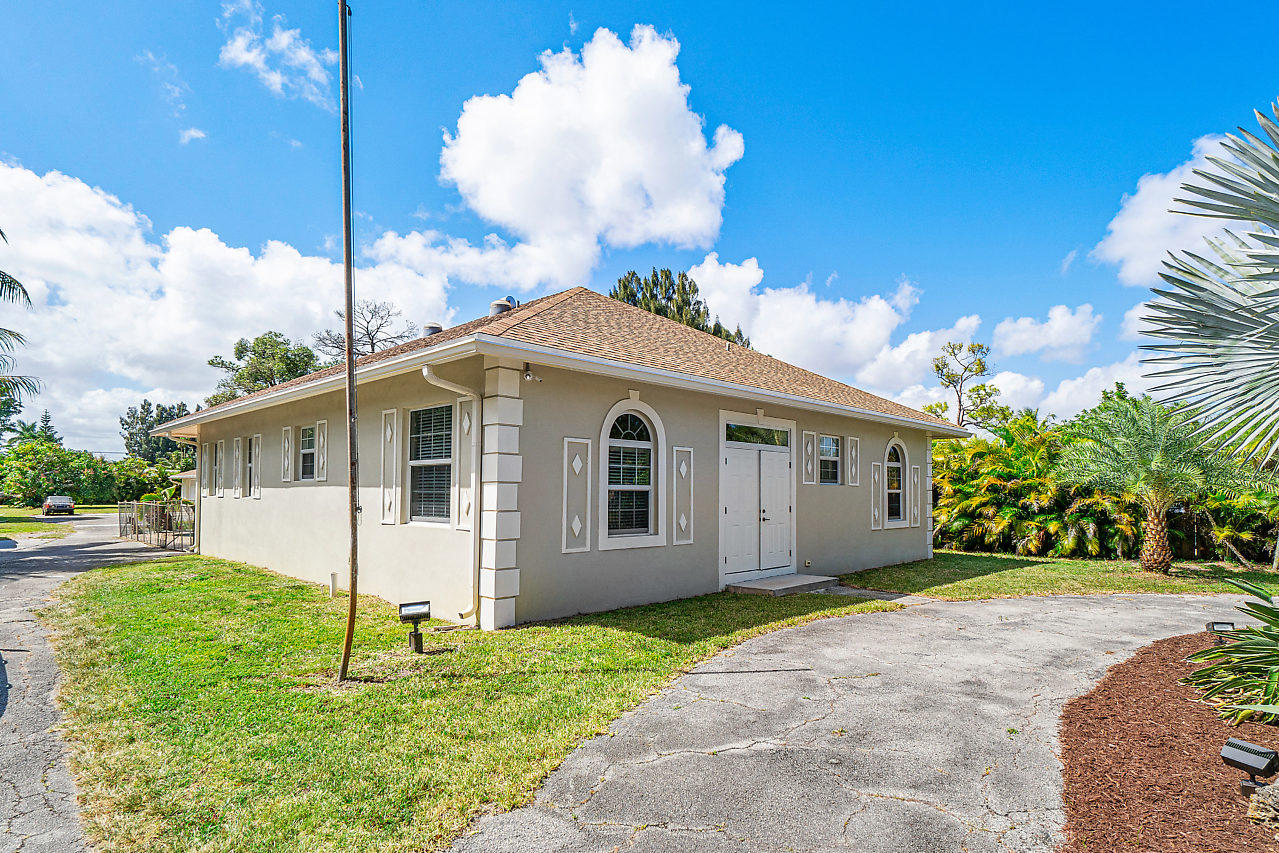 3605 Gulfstream Road Palm Springs, FL 33461 - Photo 20 of 35 a front view of a house with a yard and porch