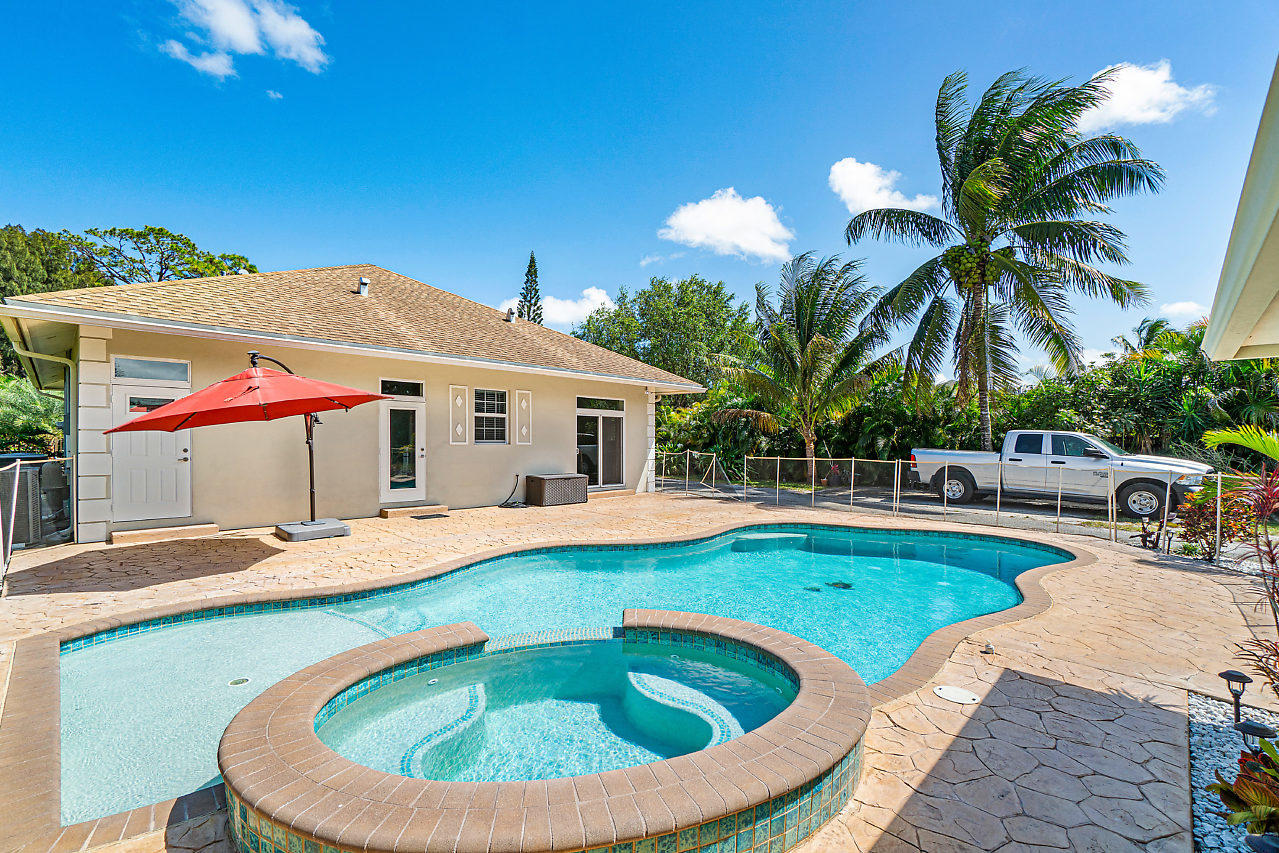 3605 Gulfstream Road Palm Springs, FL 33461 - Photo 24 of 35 a view of a house with swimming pool and sitting area