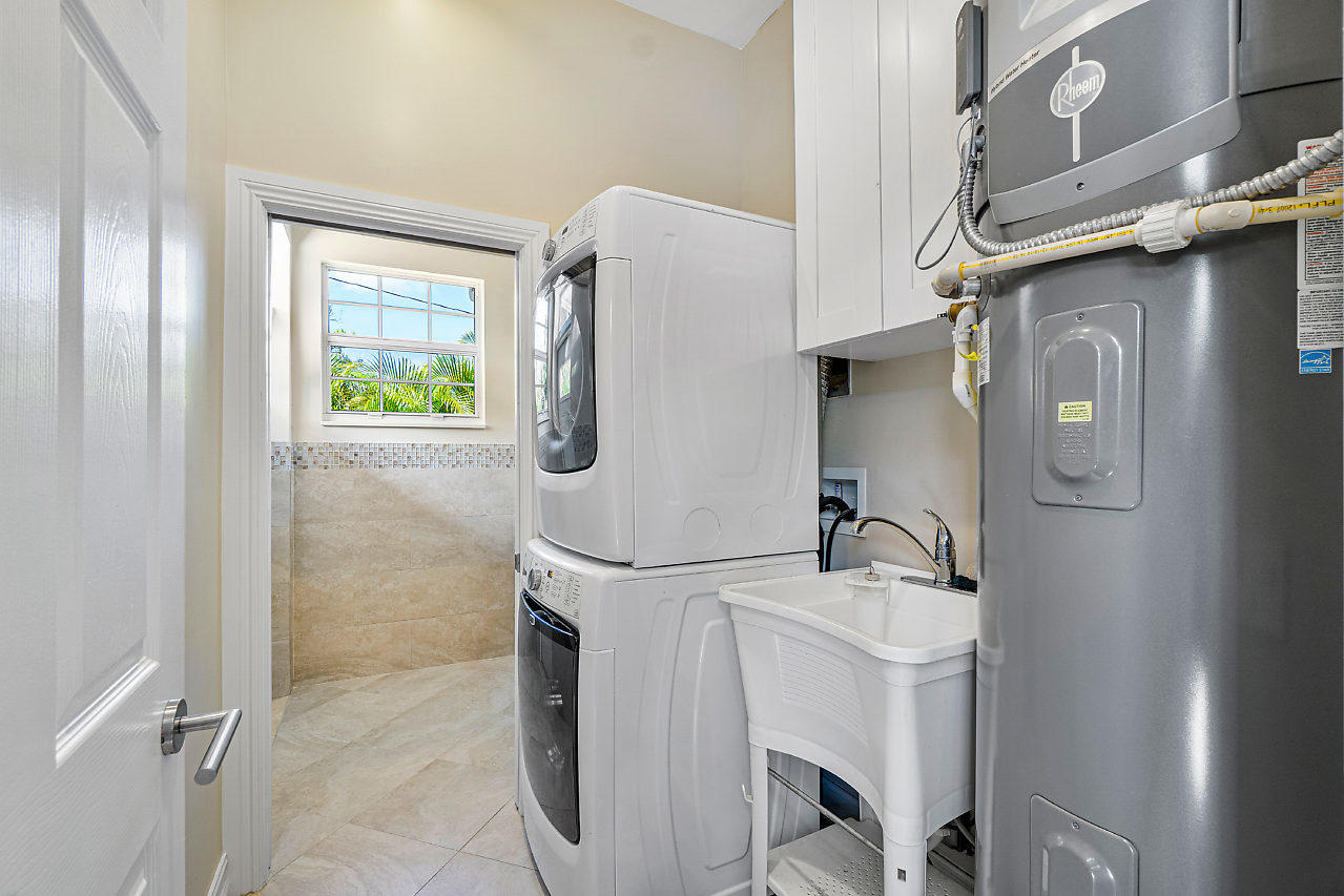 3605 Gulfstream Road Palm Springs, FL 33461 - Photo 26 of 35 a bathroom with a sink vanity and a mirror
