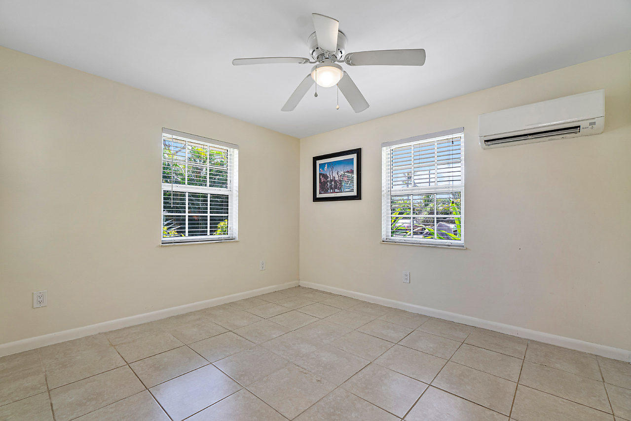 3605 Gulfstream Road Palm Springs, FL 33461 - Photo 28 of 35 an empty room with windows and fan