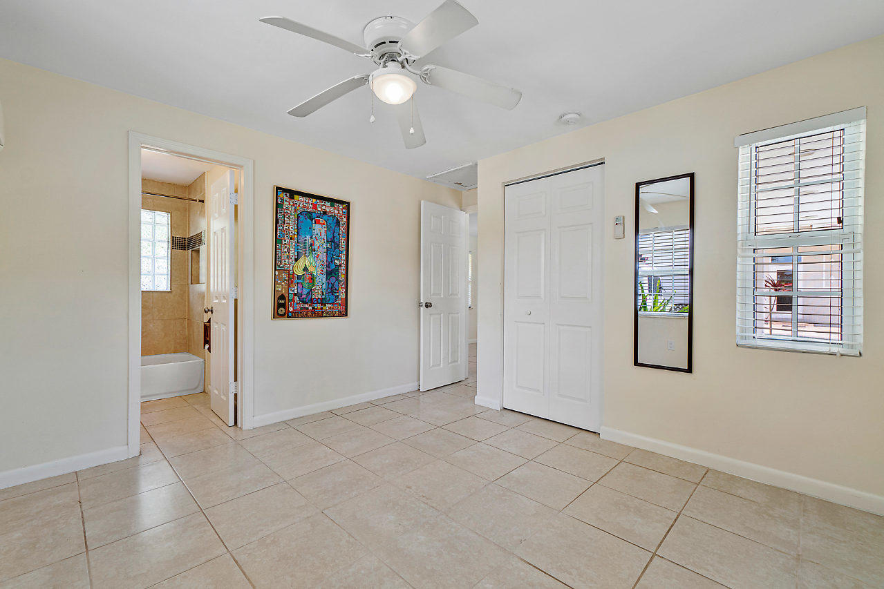3605 Gulfstream Road Palm Springs, FL 33461 - Photo 29 of 35 wooden floor in an empty room with a window