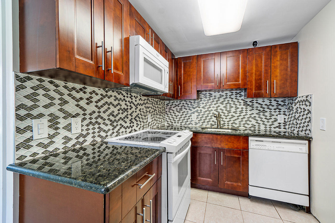 3605 Gulfstream Road Palm Springs, FL 33461 - Photo 33 of 35 a kitchen with stainless steel appliances granite countertop a stove and a sink