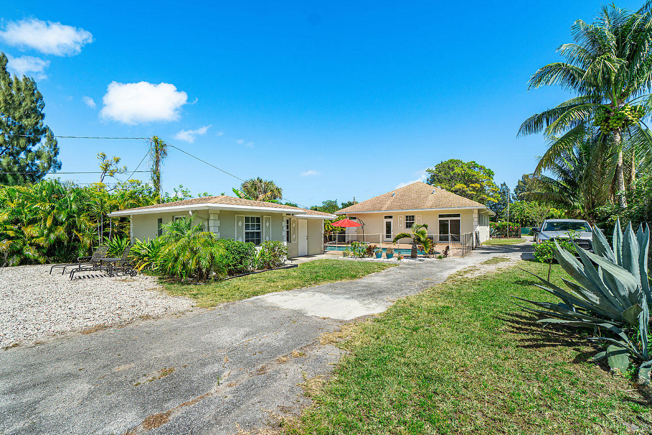 3605 Gulfstream Road Palm Springs, FL 33461 - Photo 8 of 35 a front view of a house with yard and porch