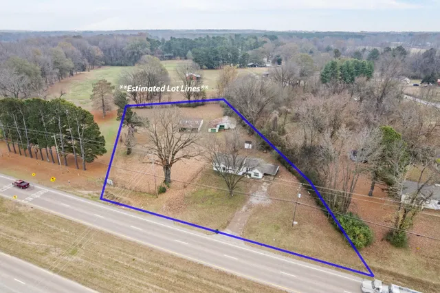 a view of a house with a yard and tree