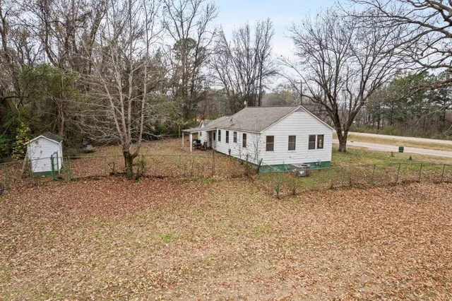 a white house that has a tree in it