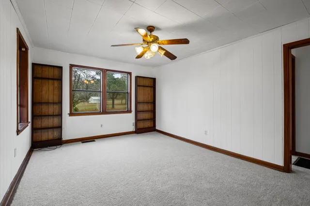 an empty room with windows and closet