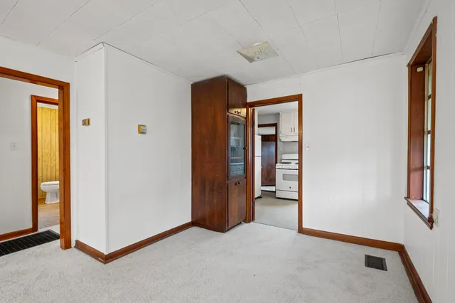 a kitchen with granite countertop cabinets appliances a sink and a window