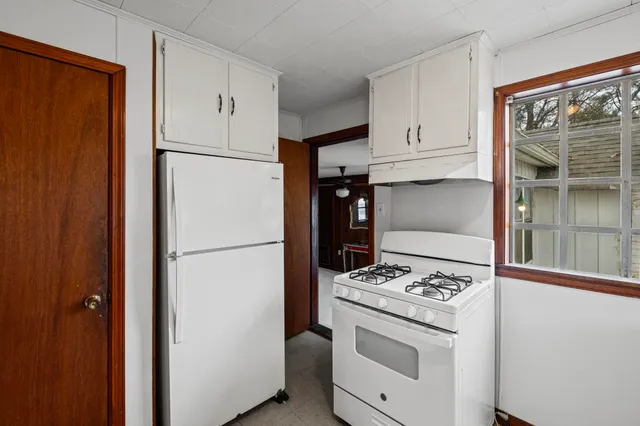 an empty room with closet and windows