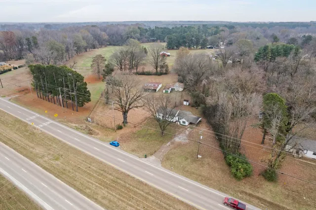 an aerial view of a house with a yard
