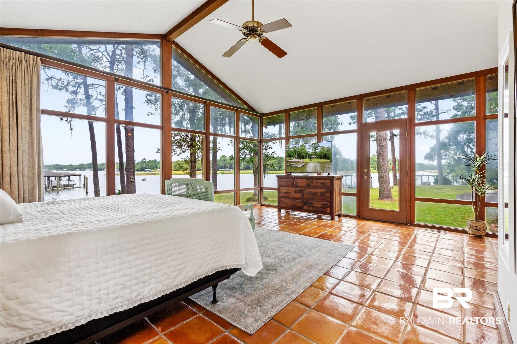 2228 Riverside Drive Mobile, AL 36605 - Photo 22 of 51 Tiled bedroom featuring a water view, ceiling fan, beamed ceiling, and multiple windows