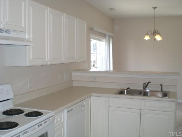 7033 Spanglers Spring Way Raleigh, NC 27610 - Photo 5 of 12 a kitchen with a sink cabinets and window