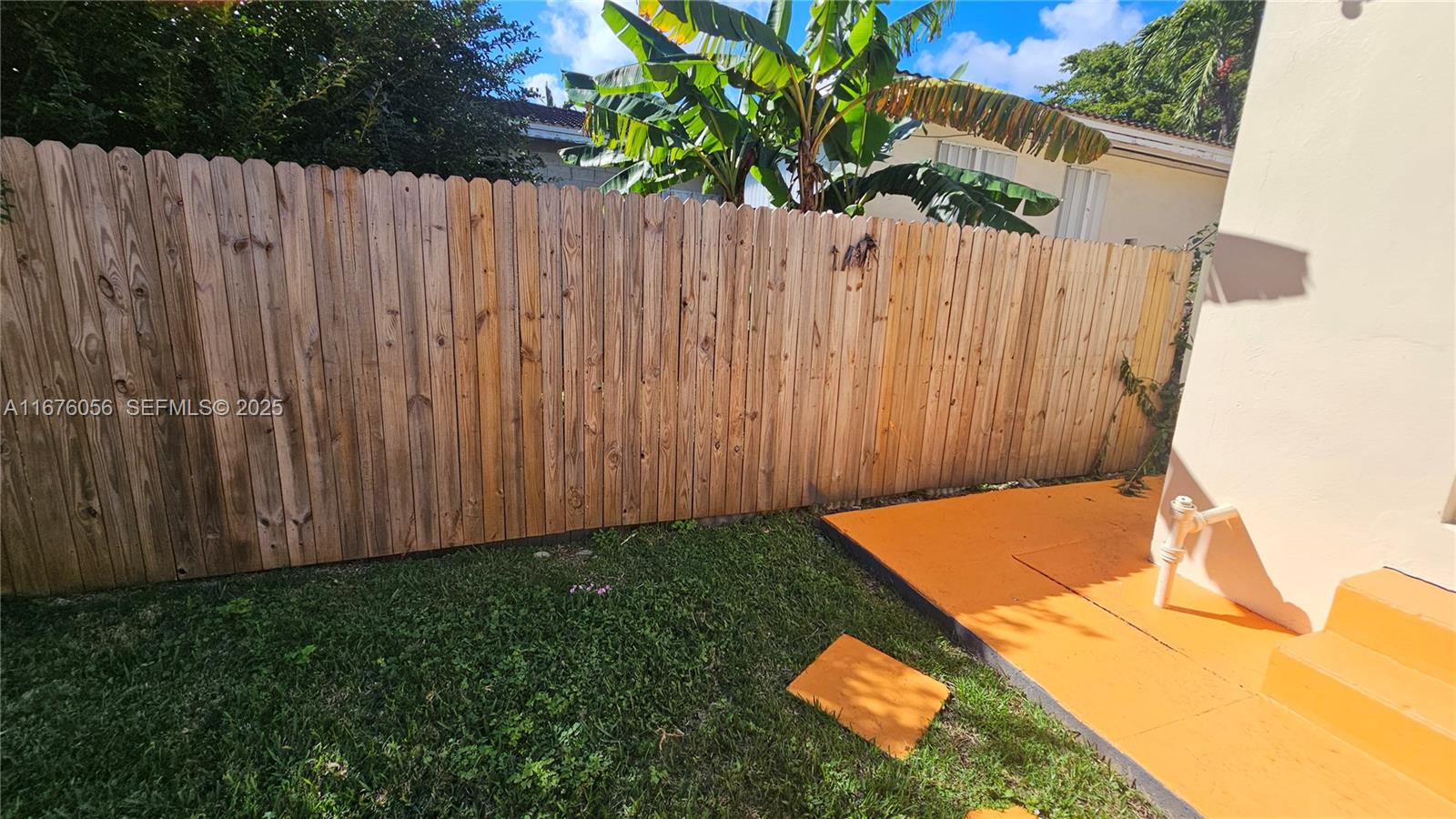 156 Northwest 88th Street El Portal, FL 33150 - Photo 15 of 56 a view of a backyard with a wooden fence