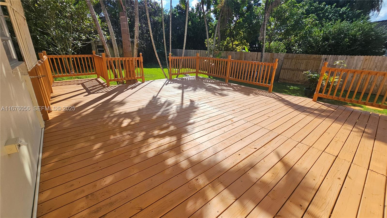 156 Northwest 88th Street El Portal, FL 33150 - Photo 21 of 56 a view of a backyard with wooden floor and fence