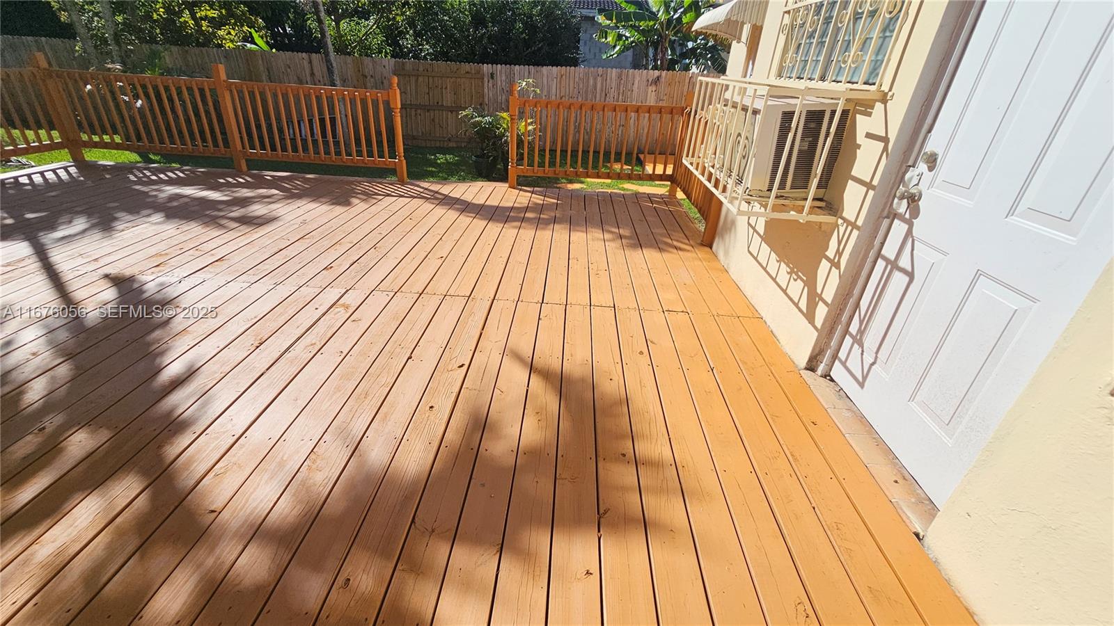 156 Northwest 88th Street El Portal, FL 33150 - Photo 23 of 56 a view of deck with wooden floor and fence