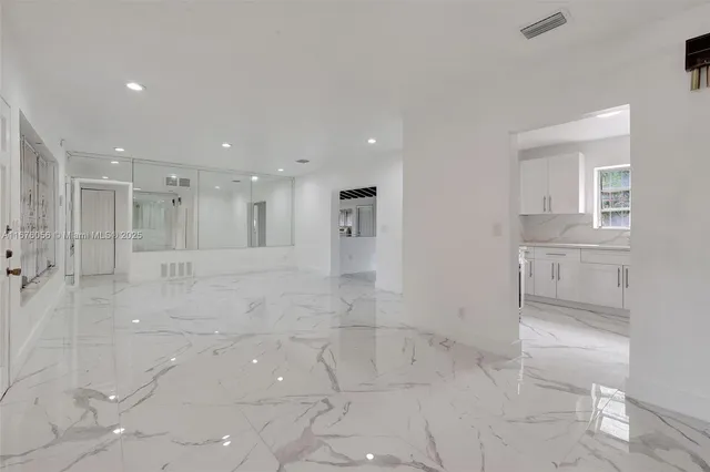 a kitchen with a refrigerator and a sink