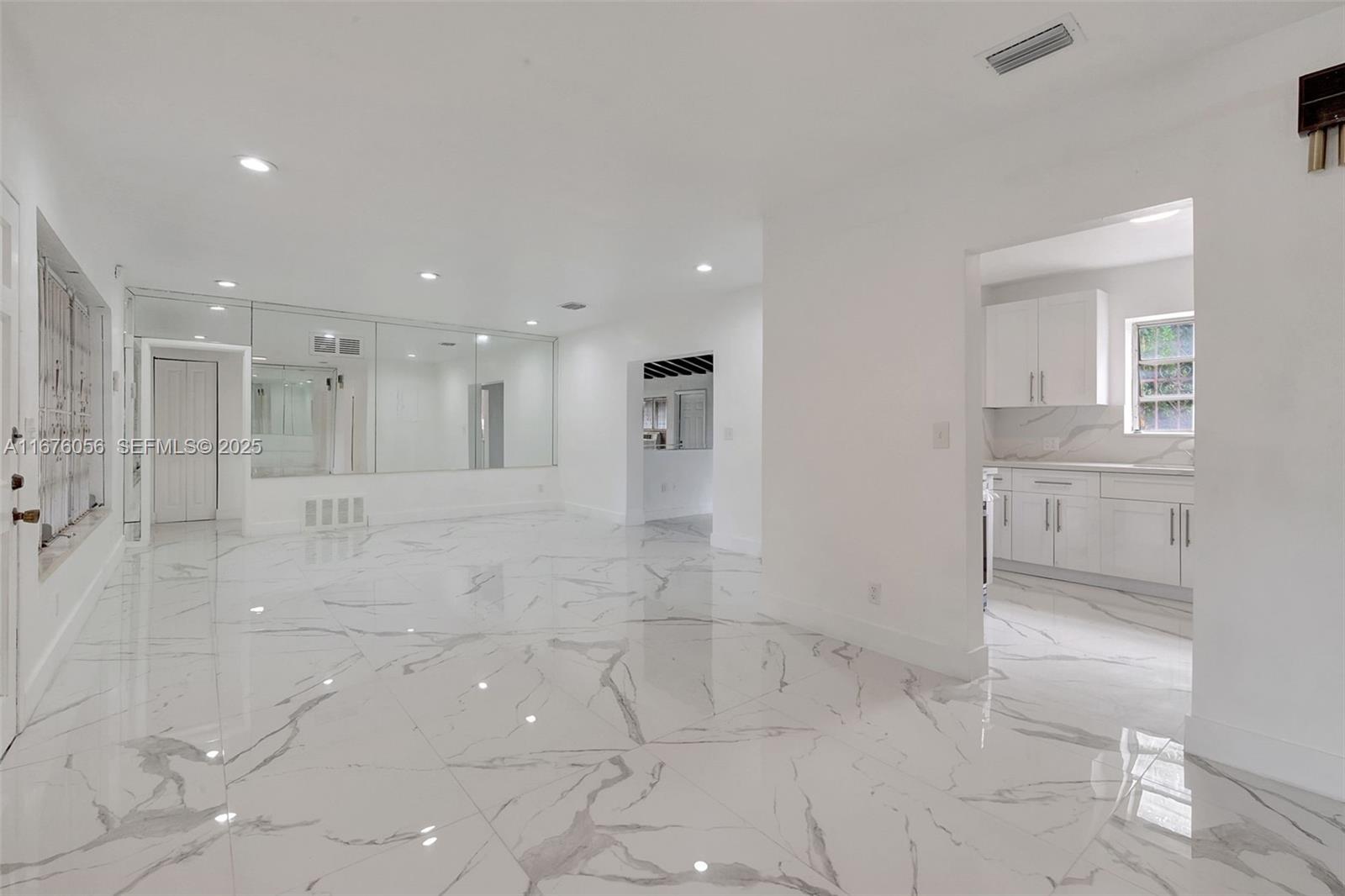 156 Northwest 88th Street El Portal, FL 33150 - Photo 27 of 56 a bathroom with a glass shower door and a bathtub