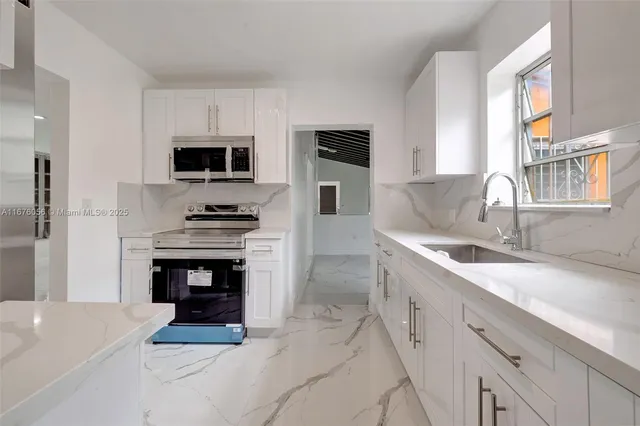 a view of a hallway with wooden floor and a living room