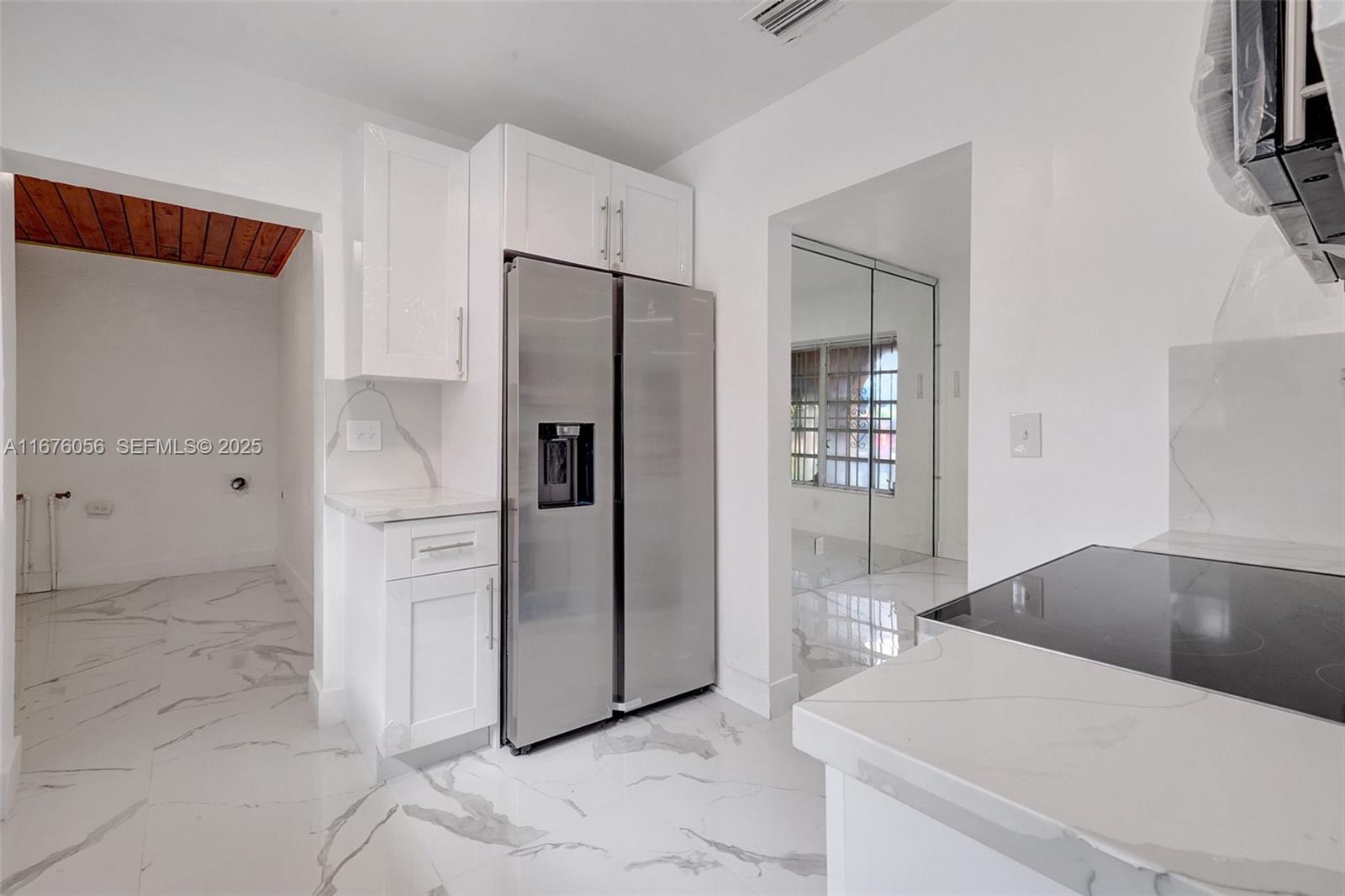 156 Northwest 88th Street El Portal, FL 33150 - Photo 32 of 56 a kitchen with a refrigerator and a sink