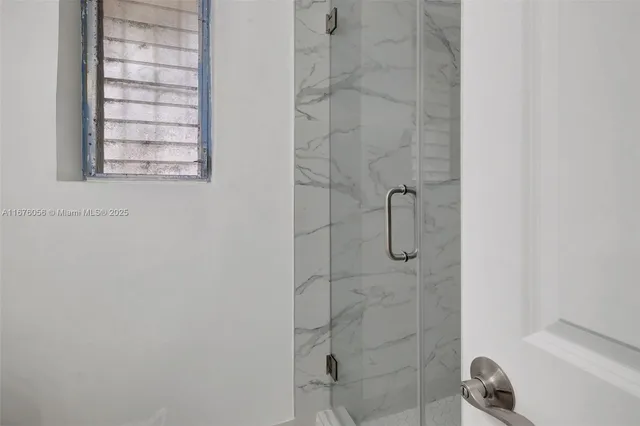 an aerial view of a house with swimming pool and a yard