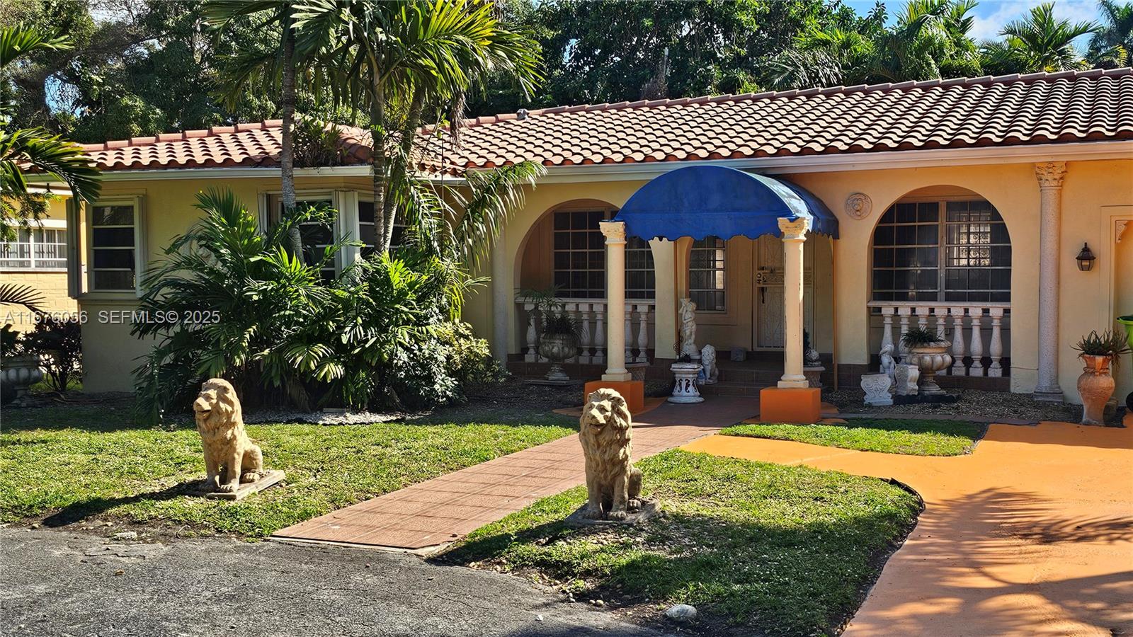 156 Northwest 88th Street El Portal, FL 33150 - Photo 4 of 56 a front view of a house with garden