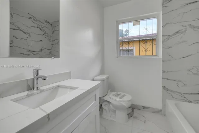 an aerial view of house with yard and swimming pool