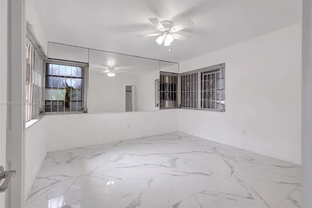 an aerial view of residential houses with outdoor space and trees