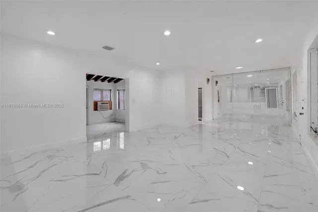 an aerial view of residential houses with outdoor space and trees