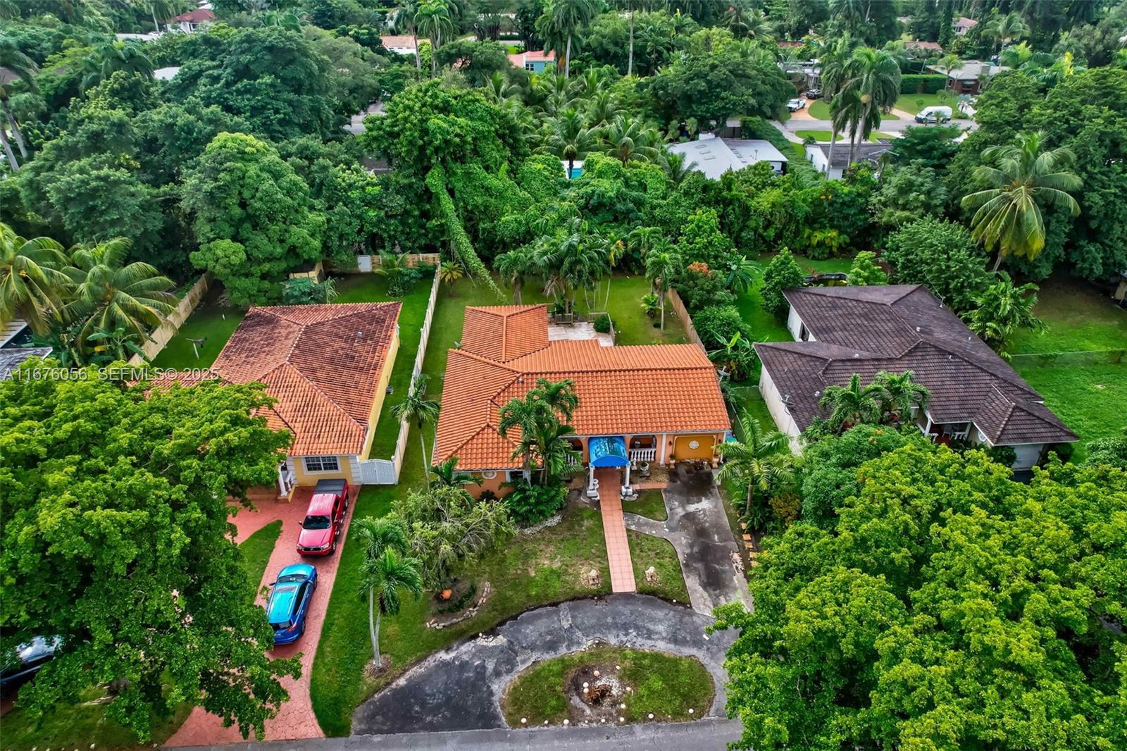 156 Northwest 88th Street El Portal, FL 33150 - Photo 45 of 56 an aerial view of a house with swimming pool and a yard