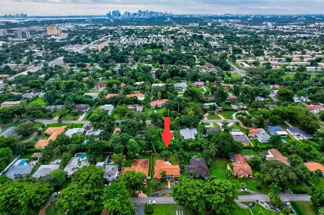an aerial view of a houses with a yard