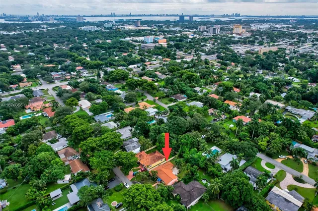 an aerial view of a house with garden space and street view