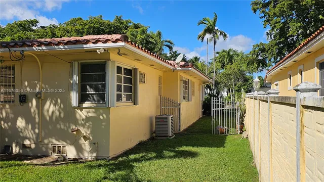a porch with a bench in front of house