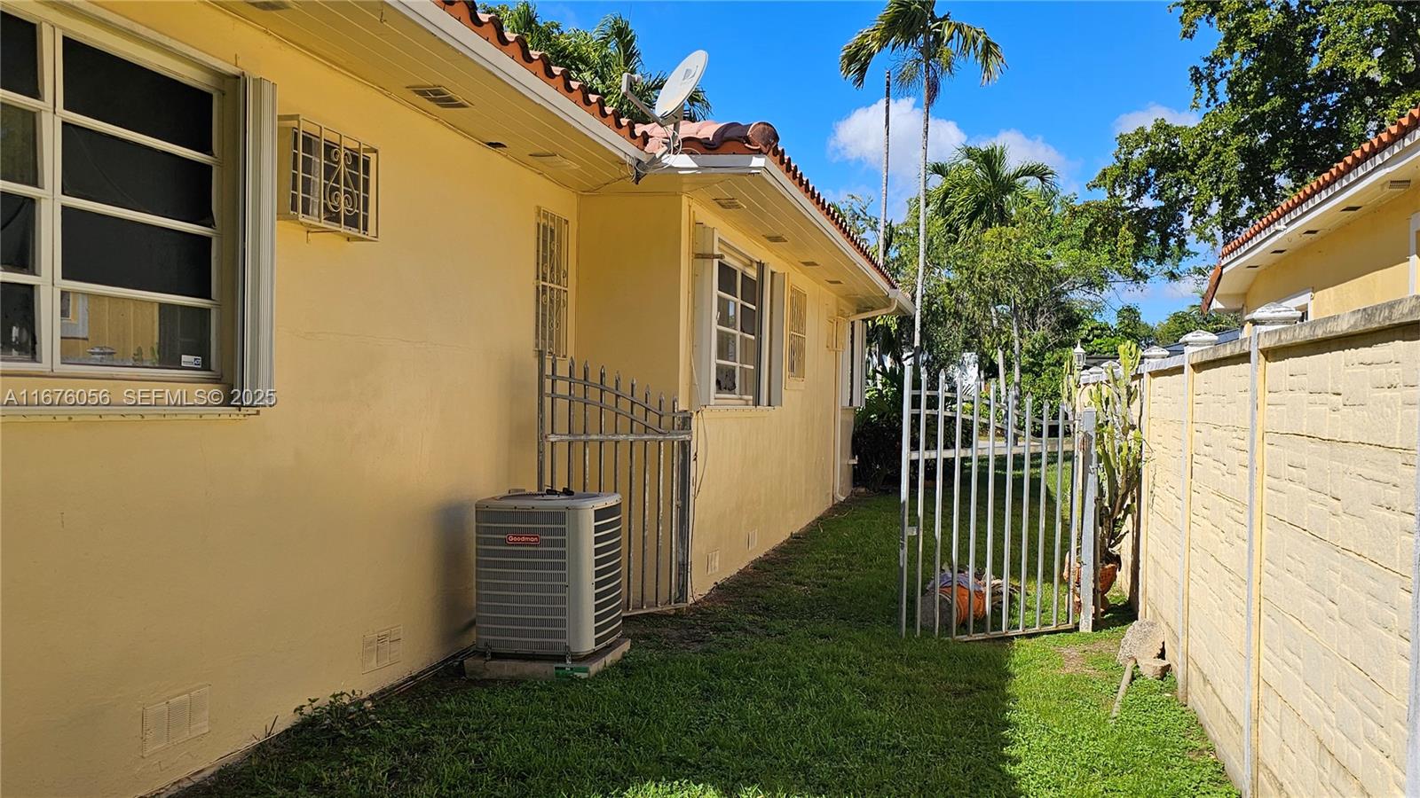 156 Northwest 88th Street El Portal, FL 33150 - Photo 9 of 56 a porch with a bench in front of house