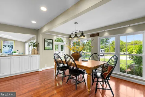 a living room with furniture and a large window with wooden floor