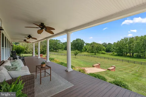 a view of a house with backyard sitting area and garden