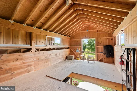 an aerial view of residential houses with outdoor space and trees all around