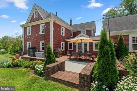 a front view of a house with yard and green space