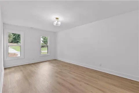 a view of an empty room with wooden floor