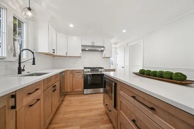 a kitchen with a sink stainless steel appliances and cabinets