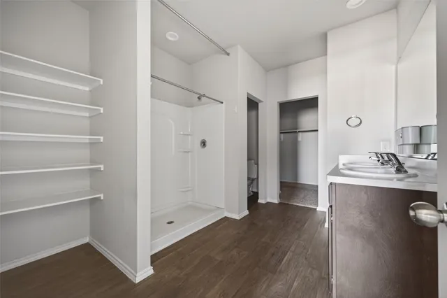 a view of bathroom with a sink mirror and shower