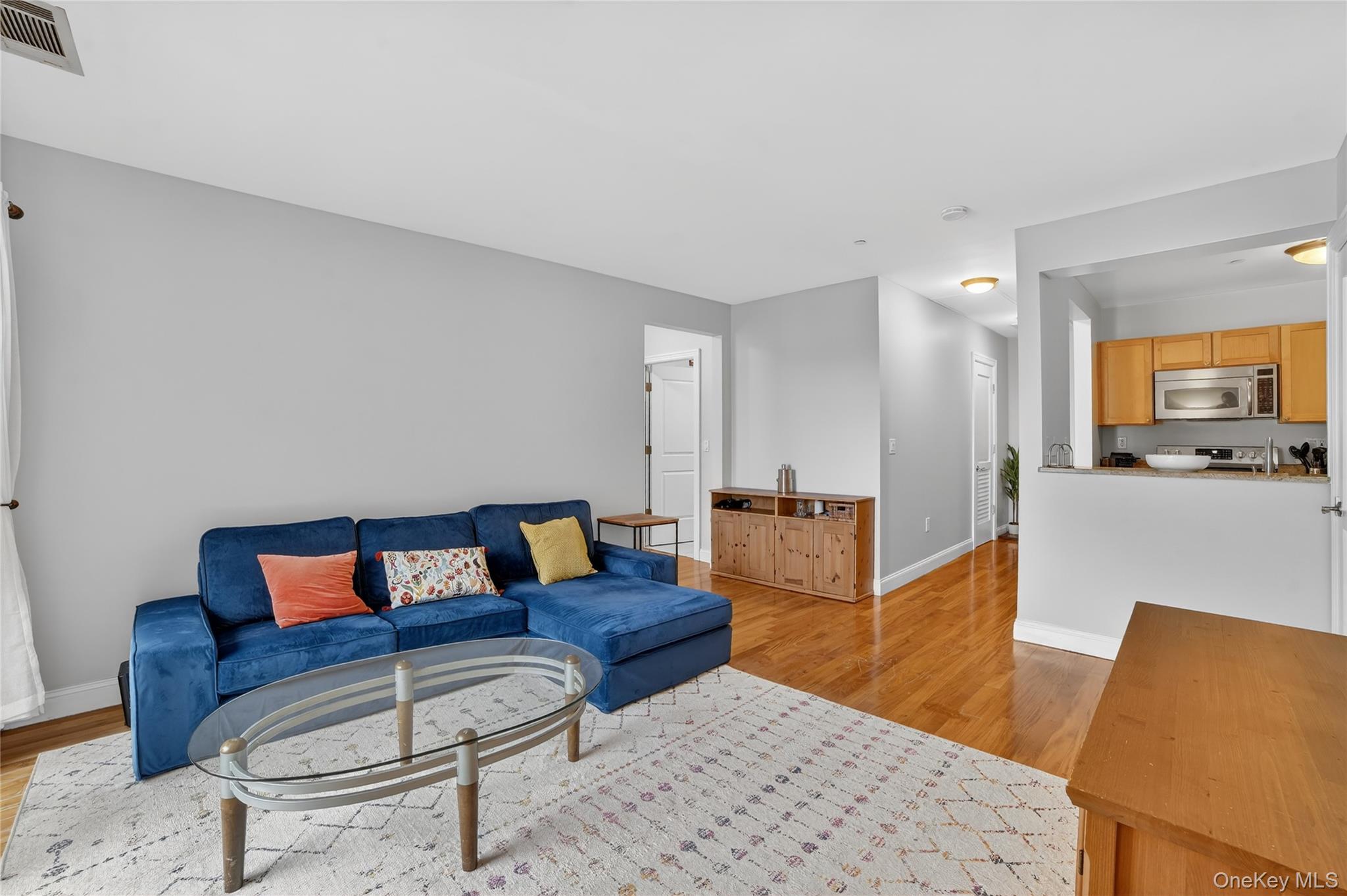 543 Main Street, Unit 502 New Rochelle, NY 10801 - Photo 12 of 31 The living room is open to the kitchen.