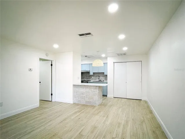 a view of a kitchen with a sink and a refrigerator