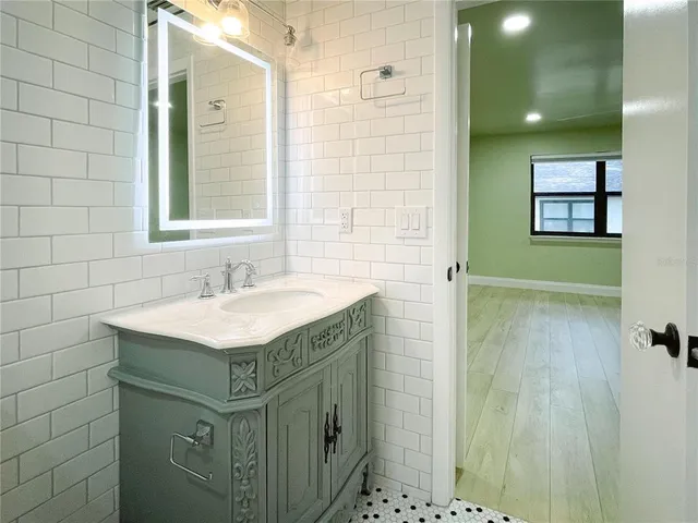 a bathroom with a sink vanity and a mirror