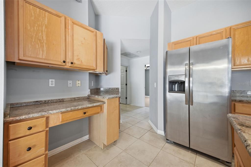 3209 Partridge Point Trail Valrico, FL 33596 - Photo 12 of 66 a kitchen with stainless steel appliances granite countertop a refrigerator and a stove
