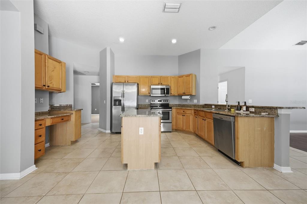 3209 Partridge Point Trail Valrico, FL 33596 - Photo 13 of 66 a large kitchen with cabinets and stainless steel appliances