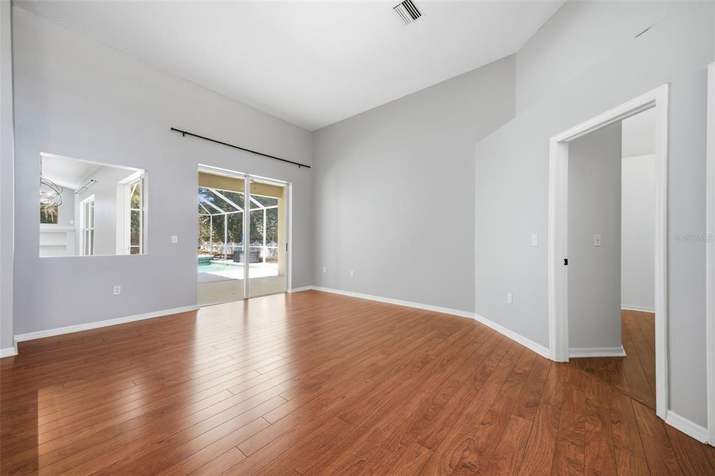 3209 Partridge Point Trail Valrico, FL 33596 - Photo 19 of 66 a view of an empty room with wooden floor and a window