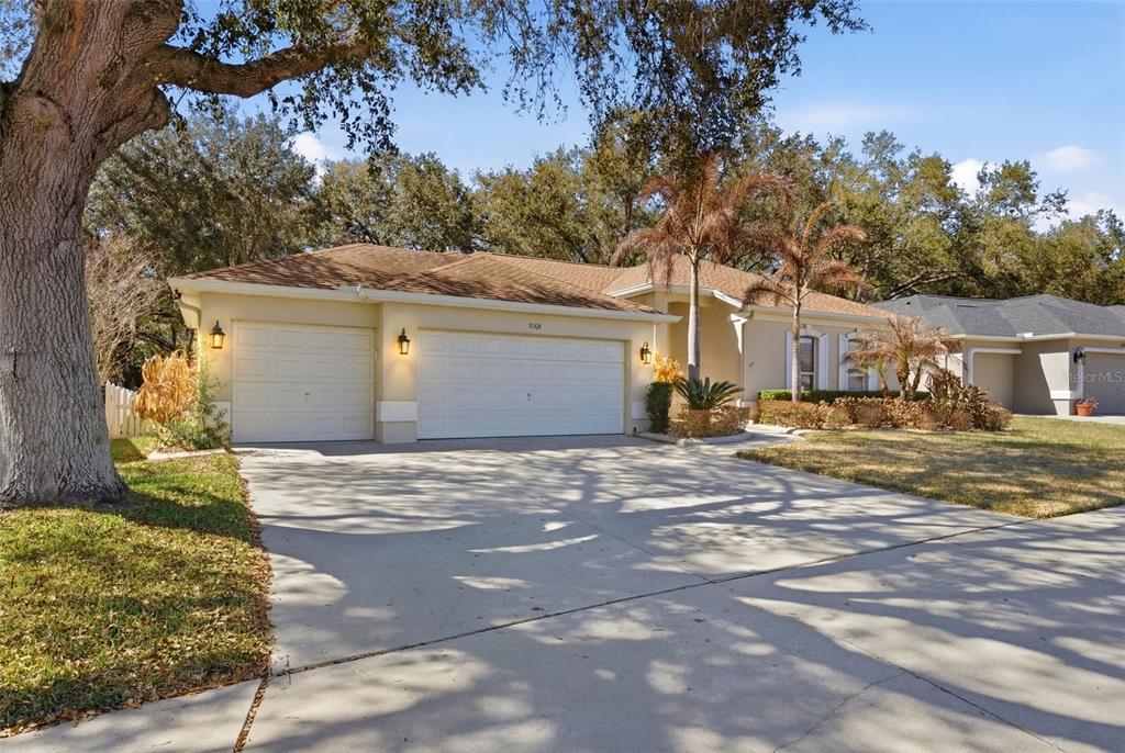 3209 Partridge Point Trail Valrico, FL 33596 - Photo 3 of 66 a front view of a house with a yard and garage