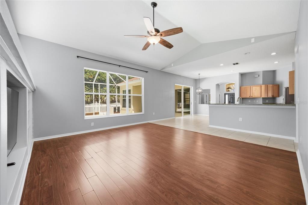 3209 Partridge Point Trail Valrico, FL 33596 - Photo 32 of 66 a view of a livingroom with wooden floor and a kitchen