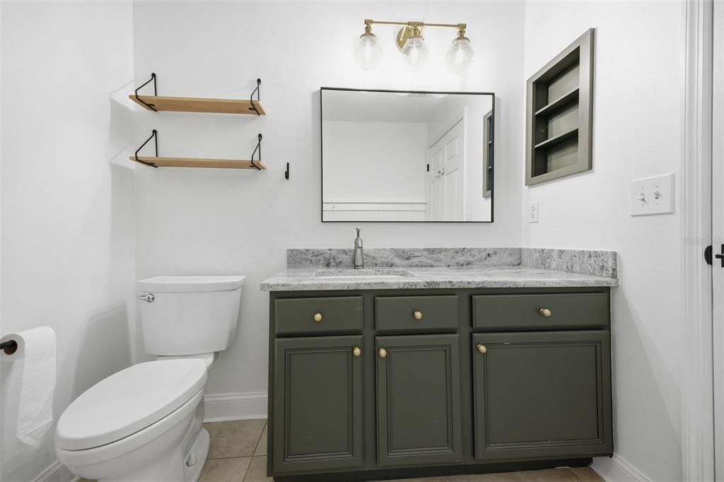 3209 Partridge Point Trail Valrico, FL 33596 - Photo 43 of 66 a bathroom with a toilet sink and mirror